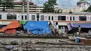 Aktivitas warga korban penggusuran di tenda pengungsian RT 006/004, Kampung Bandan, Ancol, Jakarta, Kamis (16/7/2020). Sebanyak 36 KK terdampak penggusuran bangunan di bantaran rel tersebut bertahan di tenda pengungsian yang didirikan secara mandiri. (merdeka.com/Iqbal S. Nugroho)