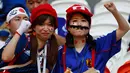 Dua suporter wanita mengenakan atribut unik sebelum pertandingan grup H Piala Dunia 2018 melawan Kolombia di Mordovia Arena di Saransk, Rusia (19/6). Para suporter tim samurai biru ini tampil unik saat mendukung negaranya berlaga. (AFP Photo/Jack Guez)