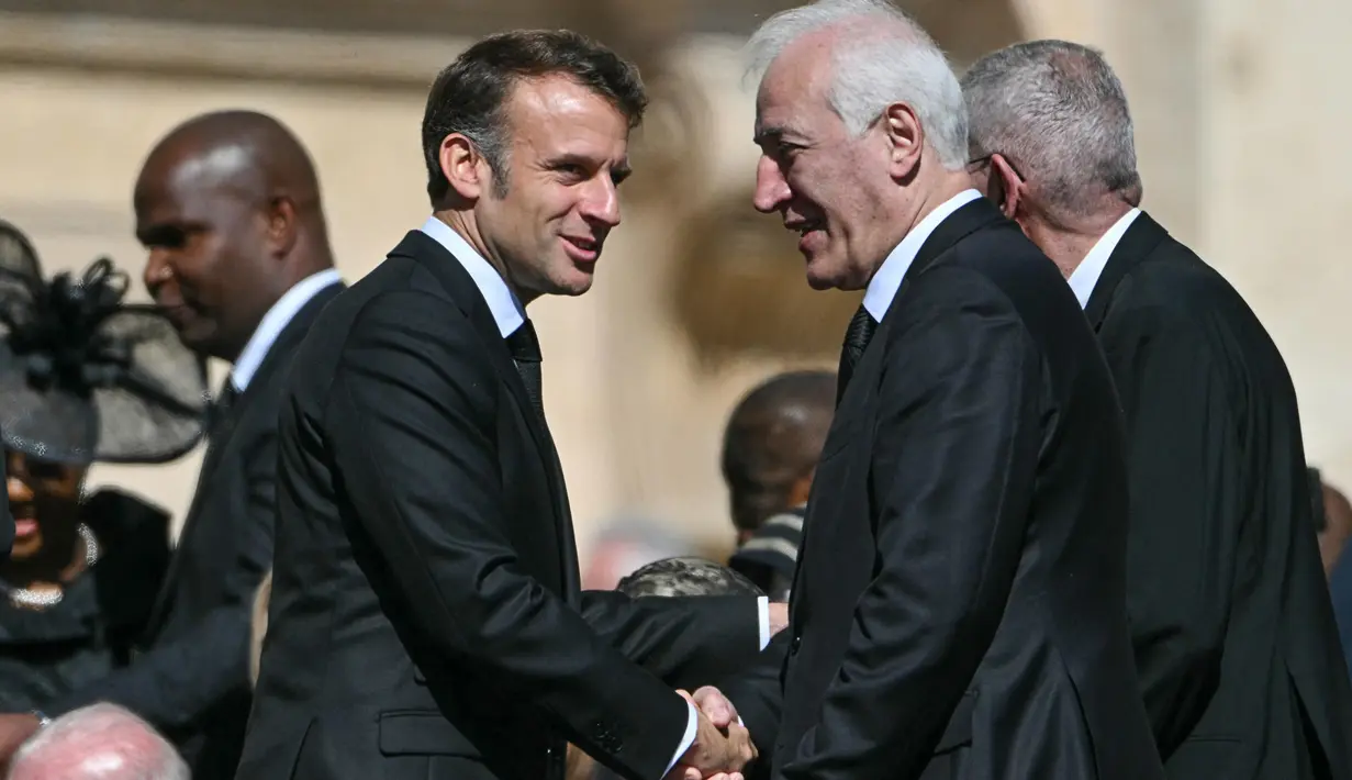 Presiden Prancis Emmanuel Macron (kiri) tiba untuk mengikuti misa pemakaman mendiang Paus Fransiskus di Lapangan Santo Petrus di Vatikan pada 26 April 2025. (Alberto PIZZOLI/AFP)