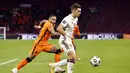 Gelandang Latvia, Vladislavs Fyodorovs (kanan) menguasai bola dibayangi striker Belanda, Memphis Depay dalam laga Kualifikasi Piala Dunia 2022 Zona Eropa Grup G di Johan Cruijff Arena, Amsterdam, Sabtu (27/3/2021). Belanda menang 2-0 atas Latvia. (AFP/Maurice van Steen/ANP)