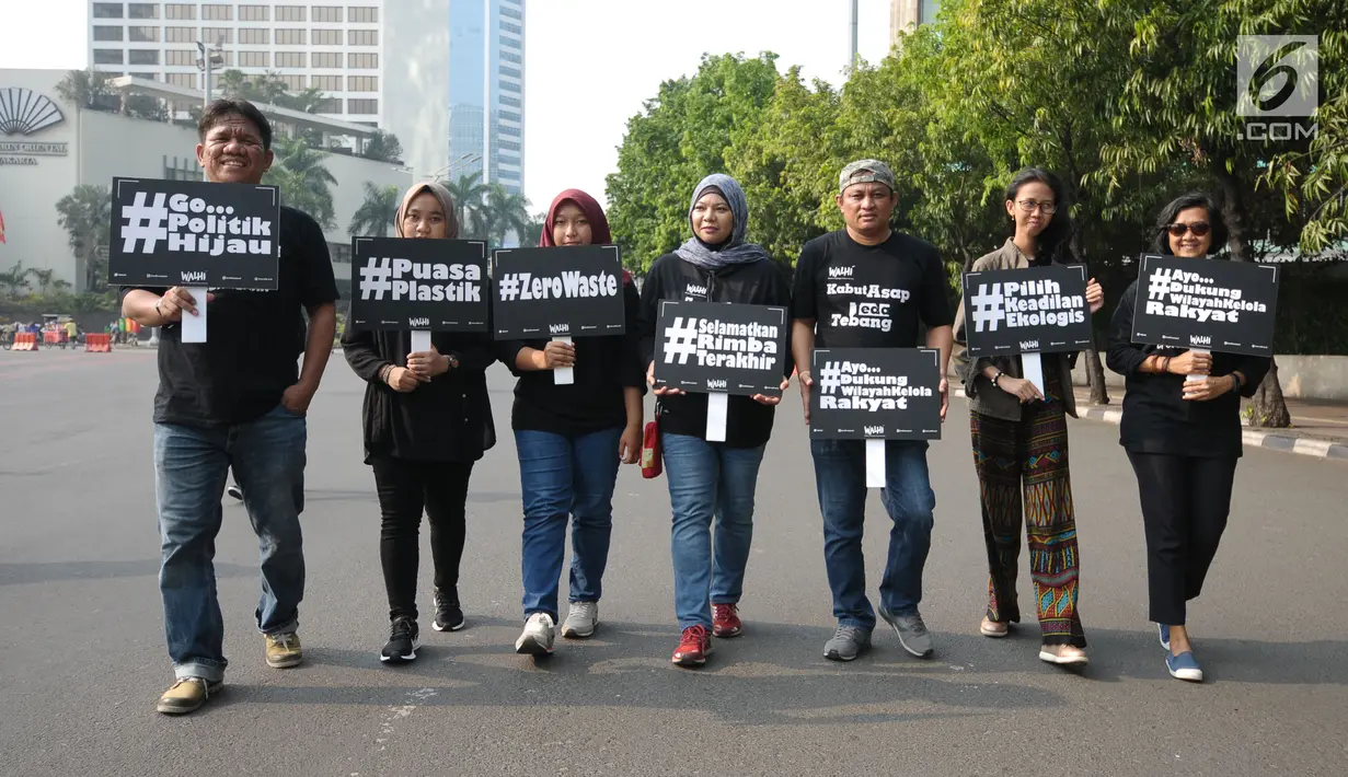 Sejumlah aktivis Walhi berjalan mengampanyekan pengurangan penggunaan plastik di kawasan Bundaran Hotel Indonesia, Jakarta, Minggu (6/3). Mereka mengajak masyarakat mengurangi penggunaan plastik. (Liputan6.com/Helmi Fithriansyah)