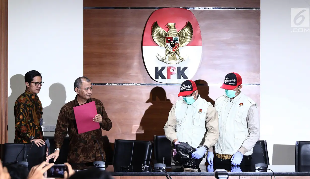 Penyidik KPK menunjukkan barang bukti uang Rp 100 Juta dari OTT Bupati Purbalingga disaksikan Ketua KPK Agus Rahardjo dan juru bicara KPK Febri Diansyah di Gedung Merah Putih KPK, Kuningan, Jakarta, Selasa (5/6). (Liputan6.com/Herman Zakharia)