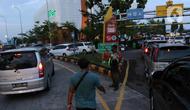 Petugas mengatur lalu lintas kendaraan yang akan memasuki rest area di KM 166 Jalan Tol Cikopo - Palimanan, Jawa Barat, Rabu (27/4/2022). Memasuki H-5 Lebaran, volume kendaraan di Jalan Tol Cikopo - Palimanan mengalami peningkatan signifikan yang mengakibatkan kemacetan pada sejumlah ruas jalan utama tol karena antrean kendaraan yang akan masuk rest area. (Liputan6.com/Herman Zakharia)