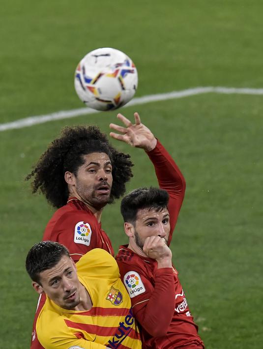 Bek Barcelona, Clement Lenglet berebut bola udara dengan dua pemain Osasuna, Jonathan Calleri dan Aridane pada pertandingan lanjutan La Liga Spanyol di stadion El Sadar di Pamplona, Spanyol, Minggu (7/3/2021). Barcelona menang atas Osasuna 2-0. (AP Photo/Alvaro Barrientos)