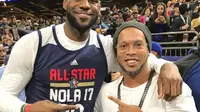 Duta besar Barcelona Ronaldinho (kanan) berpose dengan LeBron James pada NBA All-Star 2017, Senin (20/2/2017) pagi WIB. (Instagram)