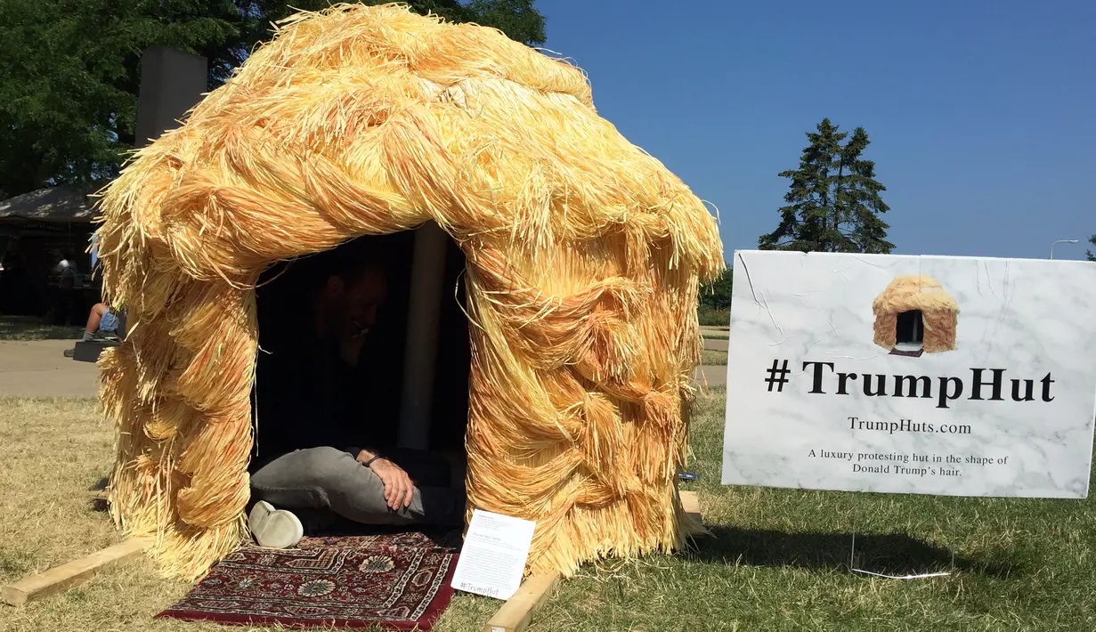 Seorang pria duduk di dalam  gubuk yang menyerupai rambut Donald Trump di Cleveland, 19 Juli 2016. Gubuk 'Trump Hut' itu bentuk sindiran kepada Trump yang diyakini bisa memperbesar kesenjangan sosial di AS bila terpilih menjadi presiden. (Nova SAFO/AFP)