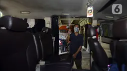 Pekerja menyemprotkan cairan disinfektan ke taksi online yang akan melakukan servis di Bengkel Yoyo, Pamulang, Tangerang Selatan, Banten, Rabu (2/4/2020). Penyemprotan disinfektan dilakukan untuk mengantisipasi  penyebaran virus corona COVID-19 antarpenumpang. (merdeka.com/Dwi Narwoko)