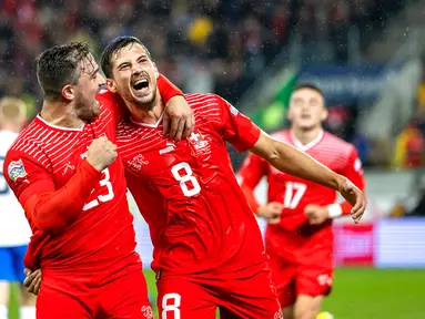 Pemain Swiss Remo Freuler (kanan) merayakan dengan Xherdan Shaqiri usai mencetak gol ke gawang Republik Ceko pada pertandingan sepak bola Grup A2 UEFA Nations League di Stadion Kybunpark, St. Gallen, Swiss, 27 September 2022. Swiss mengalahkan Republik Ceko dengan skor 2-1. (Gian Ehrenzeller/Keystone via AP)