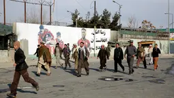 Kerabat pasien berlarian keluar menyusul serangan militan di rumah sakit militer Kabul, Afganistan, Rabu (8/3). Sejumlah pria berkostum dokter menyerang RS tersebut dan terlibat baku tembak beberapa jam dengan pasukan keamanan (AP Photos/Massoud Hossaini)