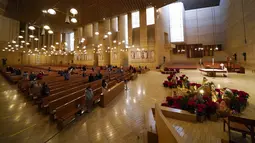 Para jemaat berkumpul untuk misa pada malam Natal di Katedral Our Lady of the Angels, Los Angeles, Amerika Serikat,  Kamis (24/12/2020). Natal tahun ini dirayakan oleh umat Kristiani dunia di tengah pandemi COVID-19. (AP Photo/Ashley Landis)