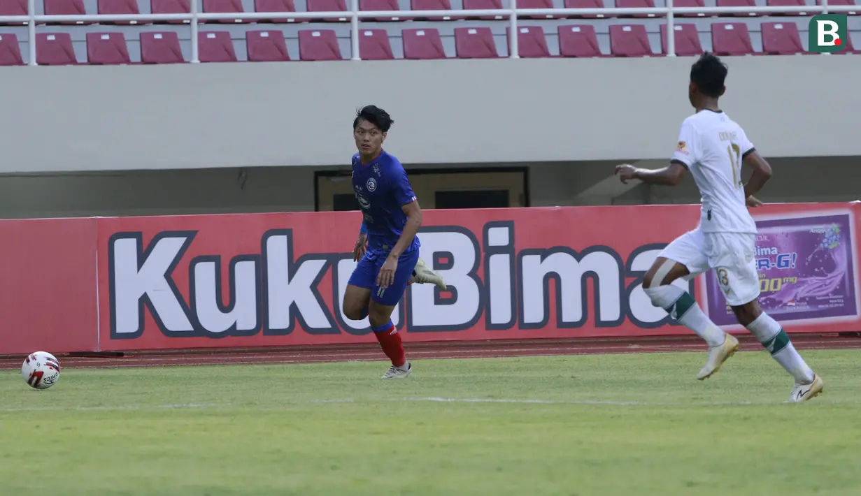 Bek Arema FC, Firza Andika (kiri) menguasai bola saat menghadapi Persikabo 1973 dalam laga pembuka Piala Menpora 2021 di Stadion Manahan, Solo, Minggu (21/3/2021). Arema FC bermain Imbang 1-1 dengan Persikabo 1973. (Bola.com/M Iqbal Ichsan)