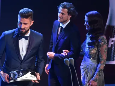 Penyerang Arsenal, Olivier Giroud meraih penghargaan Puskas Award 2017 dalam rangkaian FIFA The Best Award 2017 di The London Palladium, Senin (23/10). Gol tendangan kalajengking  Giroud jadi yang terbaik dalam malam penghargaan FIFA.  (Ben STANSALL/AFP)