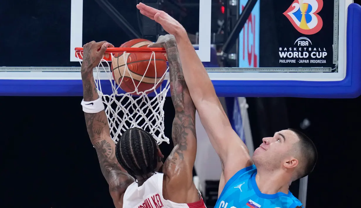 Pemain timnas basket Kanada, Nickeil Alexander-Walker (kiri) melakukan dunk melewati pebasket Slovenia Bine Prepelic pada pertandingan perempat final Piala Dunia Bola Basket di Manila, Filipina, Rabu, 6 September 2023. (AP Photo/Michael Conroy)