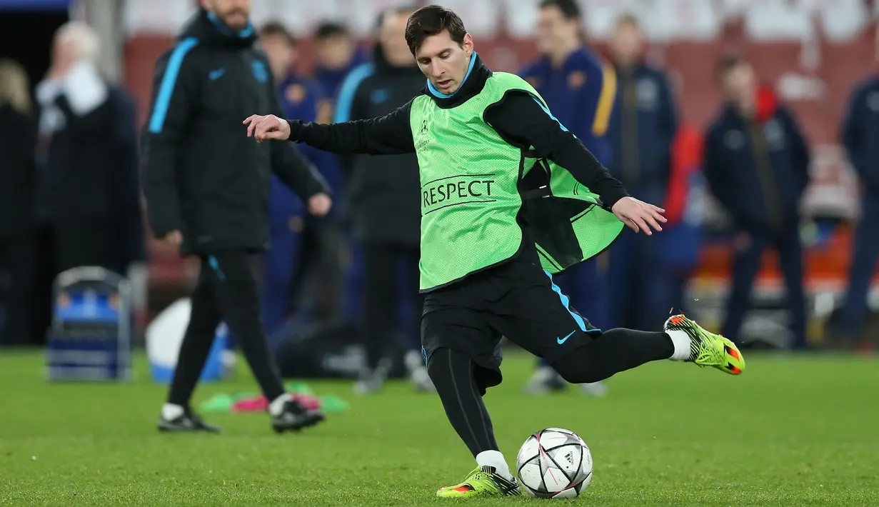 Penyerang Barcelona, Lionel Messi menendang bola saat sesi latihan di Emirates Stadium, Inggris, (23/2). Barcelona akan bertanding melawan Arsenal di leg pertama 16 besar Liga Champions. (Reuters/Matius Childs)
