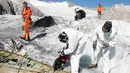 Anggota tentara Swiss memotong bagian pesawat tempur Perang Dunia II milik AS saat ditemukan di Gauli Glacier, di Bernese Alps, Swiss (17/9). Pesawat Perang Dunia II C-53 Skytrooper Dakota tersebut jatuh tahun 1946. (Peter Klaunzer/Keystone via AP)