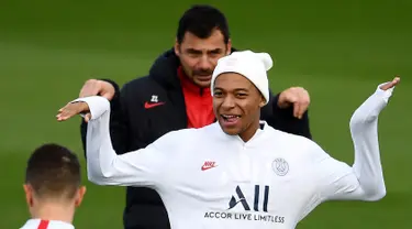 Penyerang Paris Saint-Germain Kylian Mbappe (tengah) bercanda dengan rekan-rekan setimnya saat sesi latihan jelang menghadapi Club Brugge pada laga Grup A Liga Champions di Saint-Germain-en-Laye, Paris, Prancis, Selasa (5/11/2019). (FRANCK FIFE/AFP)