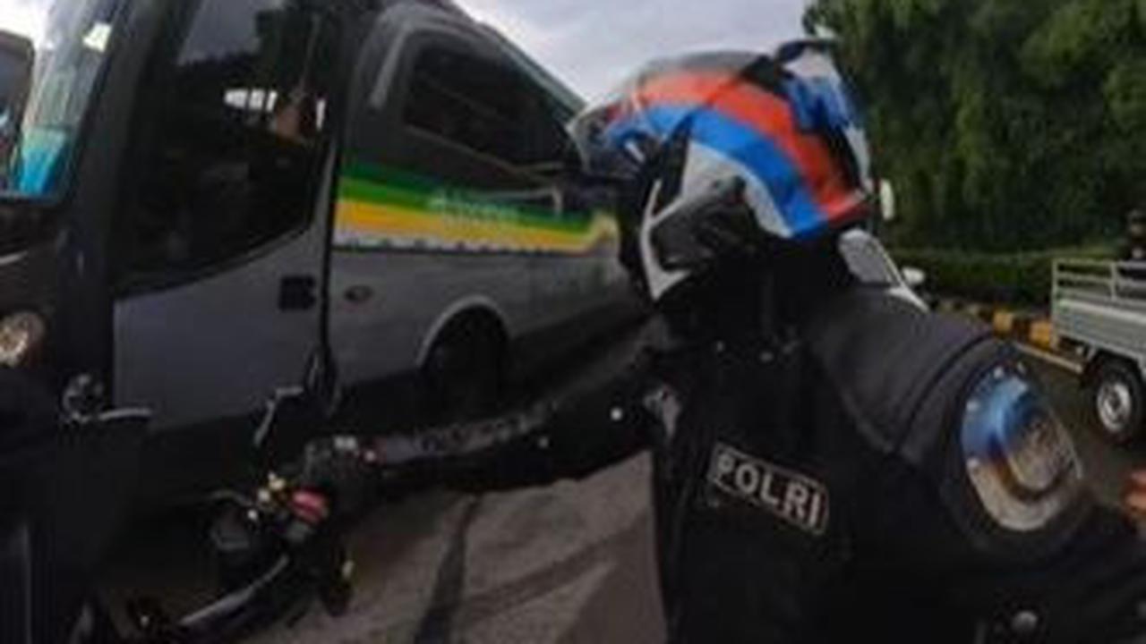 Dengan sigap ia langsung turun dari motor dan mengatur lalu lintas mobil yang juga terjebak kemacetan.