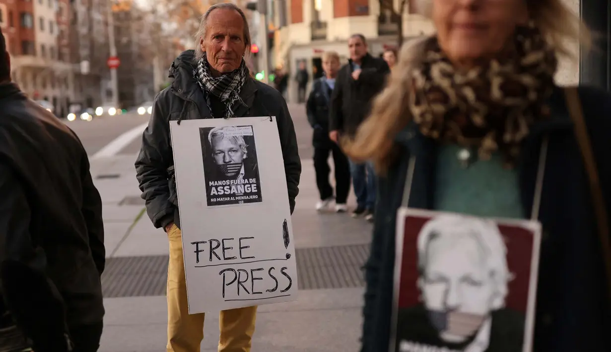 Seorang pengunjuk rasa memegang sebuah tanda dalam sebuah unjuk rasa untuk mendukung pendiri Wikileaks, Julian Assange di depan kedutaan besar Amerika Serikat di Madrid, pada tanggal 20 Februari 2024. (Thomas COEX/AFP)
