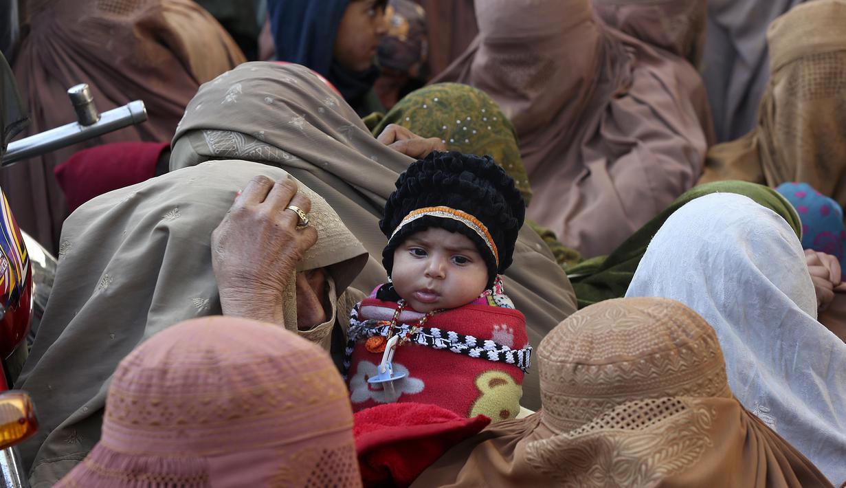 Orang-orang mengantre panjang dan menunggu untuk membeli karung tepung terigu bersubsidi di Peshawar, Pakistan, Senin, 9 Januari 2023. Pakistan saat ini sedang mengalami krisis sebagai akibat dari kekurangan tepung terigu yang parah. Pasokan tepung gratis sudah habis. (AP Photo/Muhammad Sajjad)
