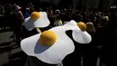 Sejumlah orang  mengenakan topi berbentuk telur mata sapi saat menghadiri Parade Paskah dan Festival Bonnet di New York City, Minggu (5/6/2015). (Reuters / Eric Thayer)