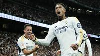 Gelandang Real Madrid, Jude Bellingham berselebrasi dengan rekan setimnya setelah mencetak gol ketiga timnya ke gawang Barcelona dalam duel pekan ke-32 La Liga 2023/2024 di Santiago Bernabeu, Senin (22/4/2024) dini hari WIB. (AP Photo/Jose Breton)