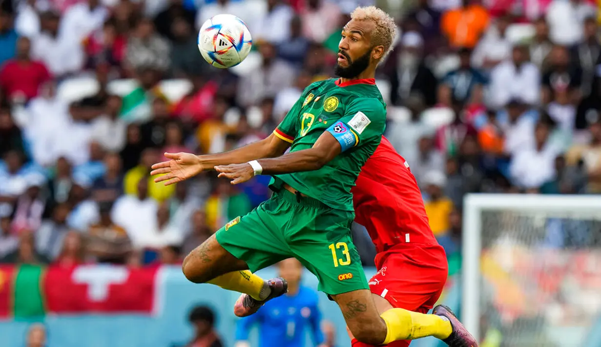 Pemain Kamerun Eric Maxim Choupo-Moting (kiri) berebut bola dengan pemain Swiss Nico Elvedi pada pertandingan sepak bola Grup G Piala Dunia 2022 di Stadion Al Janoub, Al Wakrah, Qatar, Kamis (24/11/2022). Swiss mengalahkan Kamerun dengan skor 1-0. (AP Photo/Luca Bruno)