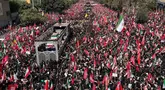 Sebuah truk yang membawa peti jenazah Pemimpin Tertinggi Iran Ayatollah Ali Khamenei dan anggota keluarganya melintas di tengah kerumunan pelayat selama prosesi pemakaman di Teheran, Iran, Senin, 6 Juli 2026. (AP Photo/Vahid Salemi)