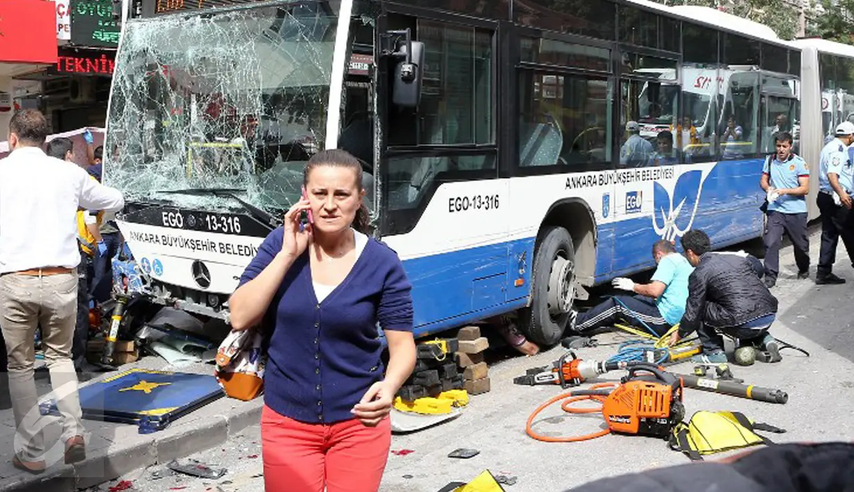 Seorang wanita berjalan di dekat lokasi kecelakaan sebuah bus menabrak halte yang penuh penumpang di distrik Dikimevi, Ankara, Turki, Kamis (1/10/2015). 12 orang tewas akibat bus kehilangan kendali karena mengalami rem blong. (AFP PHOTO/ADEM ALTAN)
