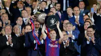 Kapten Barcelona, Andres Iniesta mengangkat trofi Copa del Rey setelah memenangkan pertandingan melawan Sevilla pada babak final di stadion Wanda Metropolitano di Madrid, Spanyol (21/4). Barcelona menang telak 5-0.  (AP Photo / Paul White)