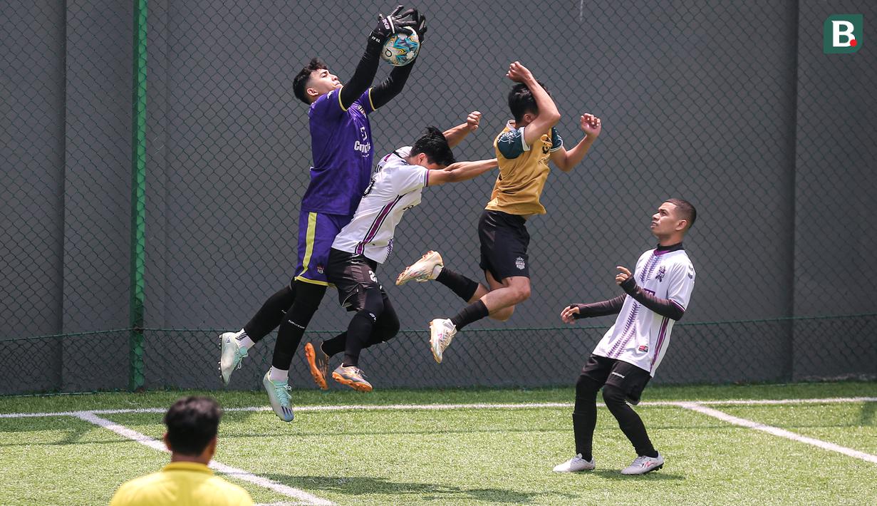 Kiper tim Golden Boutique (kiri) berusaha menangkap bola saat melawan tim Artotel pada turnamen Asatu Hoteliers Cup 2023 yang berlangsung di Asatu Area, Menteng, Jakarta, Minggu (29/10/2023). (Bola.com/Bagaskara Lazuardi)