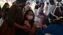 Seorang ibu mendampingi anaknya melakukan vaksin covid-19 di Stadion Utama Gelora Bung Karno (GBK), Senayan, Jakarta, Sabtu (3/7/2021). Pemprov DKI menggelar vaksinasi COVID-19 massal bagi anak usia 12-17 tahun di Stadion GBK selama dua hari, yakni pada 3-4 Juli 2021. (merdeka.com/Imam Buhori)