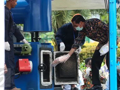 Presiden Jokowi memasukkan barang bukti narkoba yang berhasil dijaring BNN untuk dimusnahkan ke dalam mesin di Monas, Jakarta, Selasa (6/12). Ini merupakan pemusnahan narkoba yang berhasil dijaring BNN selama 2 bulan terakhir. (Liputan6.com/Faizal Fanani)