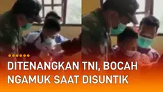 Seorang bocah laki-laki berseragam Sekolah Dasar (SD) ngamuk ketika hendak disuntik.