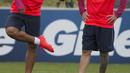 Luis Suarez menunjukan sepatu barunya kepada Messi saat sesi latihan tim Barcelona jelang laga melawan Celtic pada ajang International Champions Cup 2016 di St George's Park, Inggris (25/7/2016). (AFP/Oli Scarff)