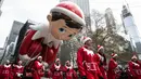 Peserta  membawa balon tokoh peri, Elf on the Shelf untuk memeriahkan parade perayaan Hari Thanksgiving di kawasan Sixth Avenue, New York, Kamis (28/11/2019). Parade yang membelah jalanan kota New York ini selalu ditunggu setiap tahunnya. (AP Photo/Jeenah Moon)