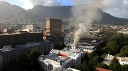Gedung yang terbakar di kawasan Parlemen Afrika Selatan di Cape Town (2/2/2022). Api tersulut di lantai tiga gedung tersebut, dan menjalar ke ruang National Assembly tempat yang menjadi basis para anggota. (AFP/Obed Zilwa)