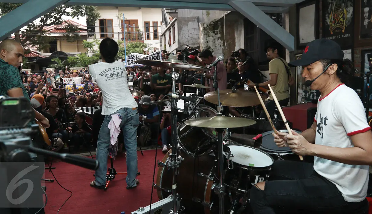 Aksi panggung Slank pada acara mini Showcase perayaan HUT Kaka Slank di Potlot, Jakarta Selatan, Jumat (10/3). Masuk diumur 43 Tahun Kaka Slank ajak para Slankers berkumpul bernyanyi bersama di Markas Slank tersebut. (Liputan6.com/Herman Zakharia)