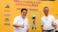 Ketua PSSI, Erick Thohir (kiri), bersama Penjabat (Pj) Gubernur DKI Jakarta, Heru Budi Hartono, memamerkan trofi Piala Dunia U-17 2023 kepada masyarakat di Bundaran Hotel Indonesia (HI), Jakarta, Minggu (15/10/2023). (Bola.com/Bagaskara Lazuardi)