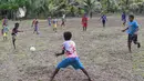 Sejumlah anak dari suku Byak Betew bermain sepak bola setelah misa hari Minggu di pulau Saukabu, satu dari 1.500 pulau di Raja Ampat 20 Agustus 2017. Raja Ampat  yang berarti Empat Raja terdiri dari 1.500 pulau. (AFP Photo/Goh Chai Hin)