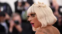 Lady Gaga mengenakan bulu mata emas saat menghadiri Met Gala 2019 yang digelar di The Metropolitan Museum of Art, New York, Amerika Serikat, Sanin (6/5/2019). Lady gaga mengenakan empat busana yang heboh dan meriah saat menghadiri Met Gala 2019. (Photo by Evan Agostini/Invision/AP)