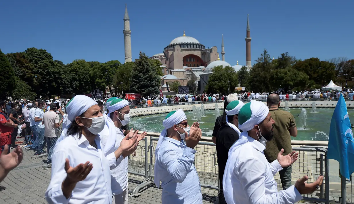Umat muslim berdoa saat salat Jumat di distrik bersejarah Sultanahmet, dekat Hagia Sophia, Istanbul, Turki, Jumat (24/7/2020). Umat muslim melaksanakan salat Jumat pertama di Hagia Sophia dalam 86 tahun terakhir. (AP Photo/Yasin Akgul)