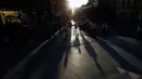 Orang-orang berjalan selama matahari terbenam di pusat kota Belgrade, Serbia, (29/5). Para ahli meteorologi meramalkan cuaca cerah di Serbia akan melanda beberapa hari mendatang. (AP Photo / Darko Vojinovic)