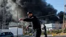 Petugas mengatur lalu lintas di sekitar perusahaan kimia Indukern yang sedang terjadi kebakaran di kawasan industri Fuente del Jarro, Paterna, Valencia, Spanyol, Rabu (8/2). (AFP PHOTO / Biel Alino)