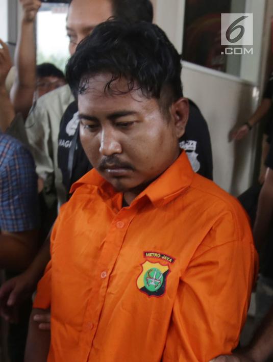 Pelaku pembunuhan wartawan Abdullah Fitri Setiawan yang tewas dalam drum M Nurhadi digiring petugas di Bogor di Polda Metro Jaya, Jakarta, Rabu (21/11). Kedua pelaku dijerat pasal pembunuhan berencana dan terancam hukuman mati. (Merdeka.com/Imam Buhori)