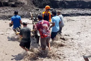 Wara Dusun Sumberlangsep, Desa Jugosari, Kecamatan Candipuro, Lumajang, memaksakan diri menyeberangi banjir lahar hujan Gunung Semeru. (Liputan6.com/ Dok Ist)
