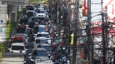 Kabel utilitas semrawut melintang di atas Jalan Ciledug Raya, Kawasan Seskoal, Kebayoran Lama, Jakarta, Selasa (8/8/2023). (Liputan6.com/Johan Tallo)