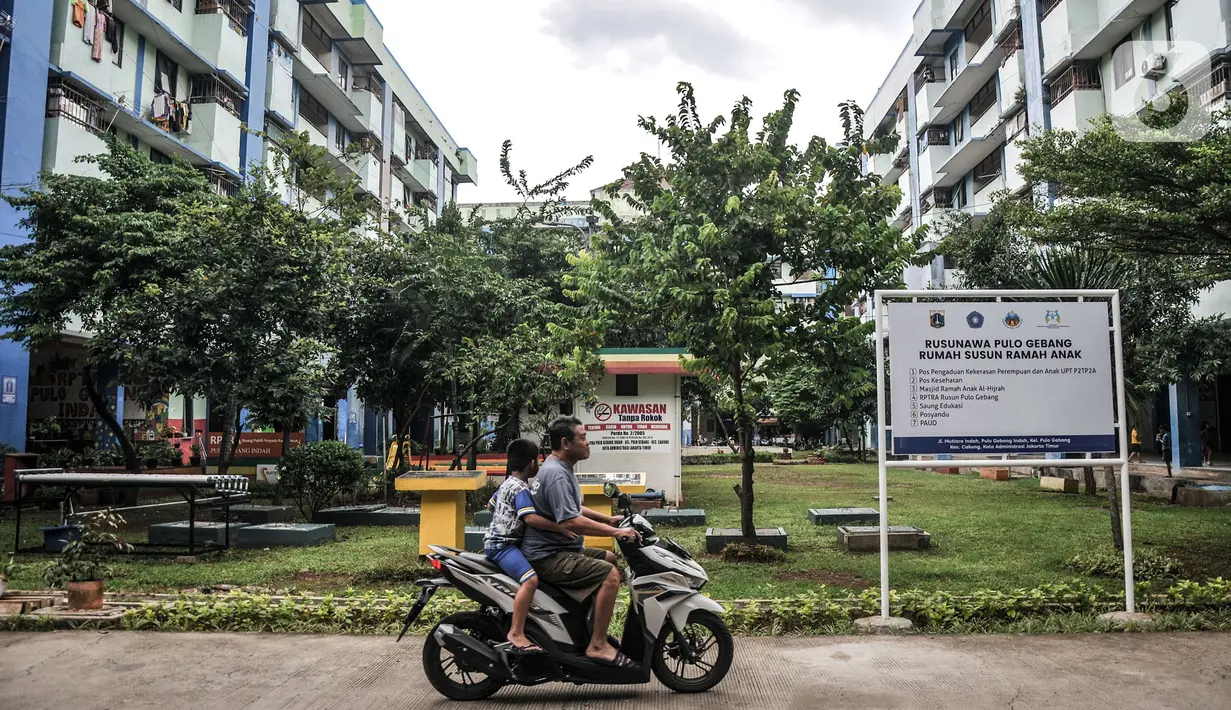 Pengendara motor melintas di depan taman salah satu tower Rusunawa Pulo Gebang Indah, Cakung, Jakarta Timur, Minggu (11/12/2022).  Dinas Pemberdayaan, Perlindungan Anak dan Pengendalian Penduduk (PPAPP) DKI Jakarta mencanangkan Rusunawa Pulo Gebang Indah, Cakung, Jakarta Timur sebagai Rumah Susun Ramah Anak (RSRA). (merdeka.com/Iqbal S Nugroho)
