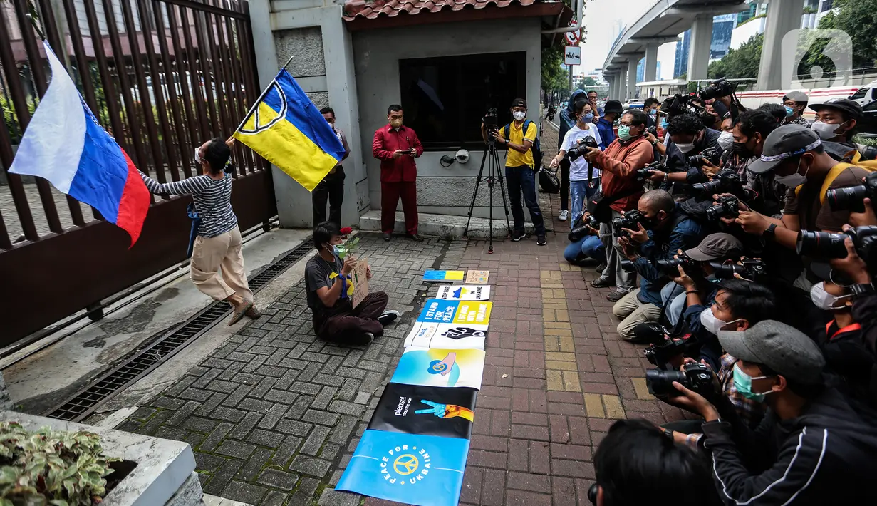 Masyarakat dari "Solidaritas untuk Rakyat Ukraina" membawa bendera Rusia dan Ukrainan di depan Kedubes Rusia, Jakarta, Jumat (4/3/2022). Mereka menyerukan kepada Dubes Rusia di Indonesia untuk bersuara menghentikan serangan yang dilakukan Rusia terhadap Ukraina. (Liputan6.com/Johan Tallo)