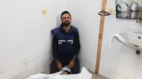 Mohammed Alaloul menangis ketika dia memeriksa jenazah keempat putranya di Rumah Sakit Al-Aqsa pada hari Minggu, 5 November 2023. (Dok: AFP)