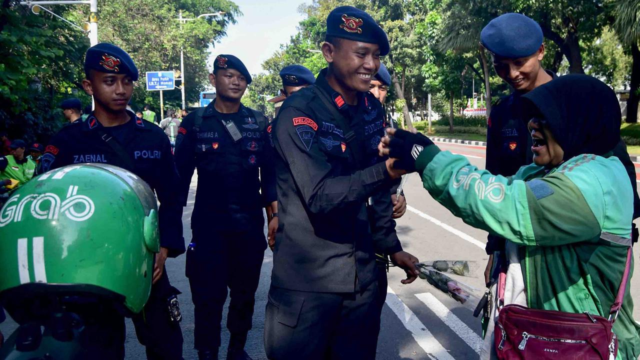 FOTO: Aksi Damai Ojol Tebar Mawar untuk Perdamaian